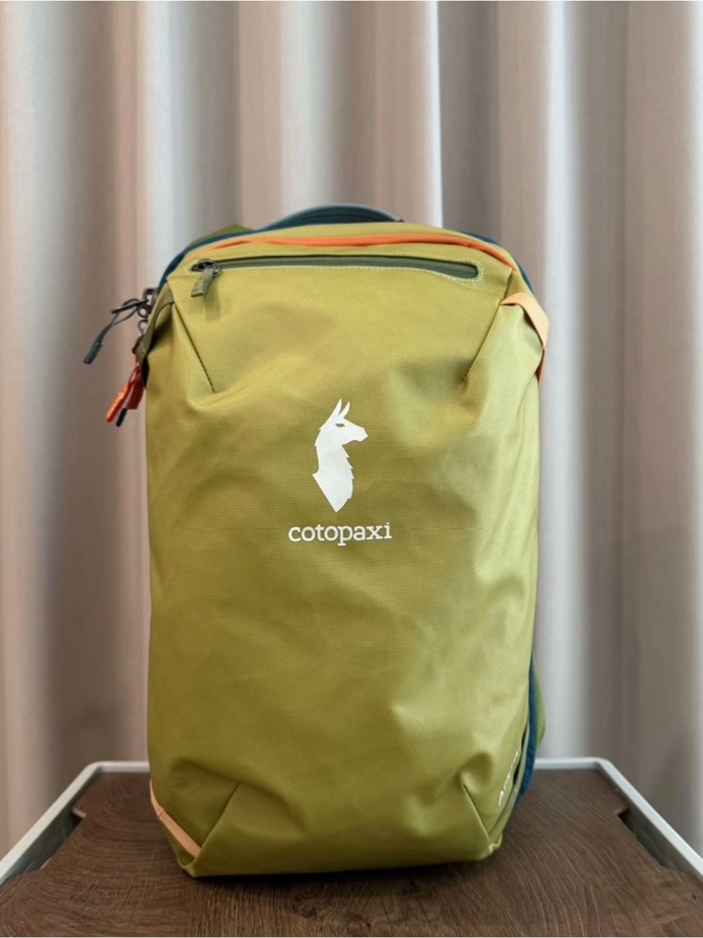 cotopaxi olive green backpack with orange accents